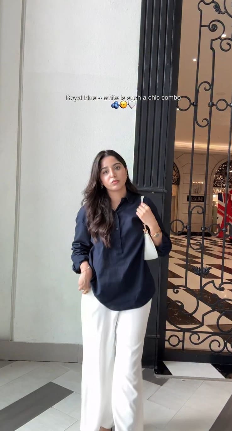 Navy oversized shirt with white wide-leg pants and white bag