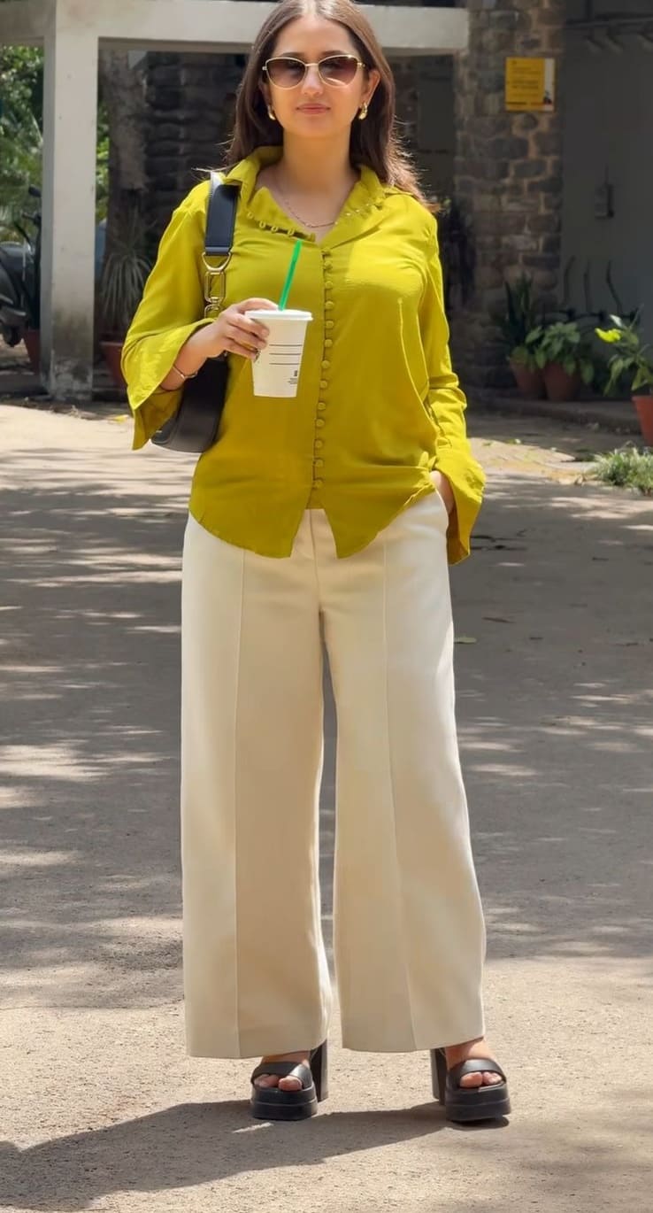 Olive green ruffle-front shirt with cream wide-leg pants and chunky sandals