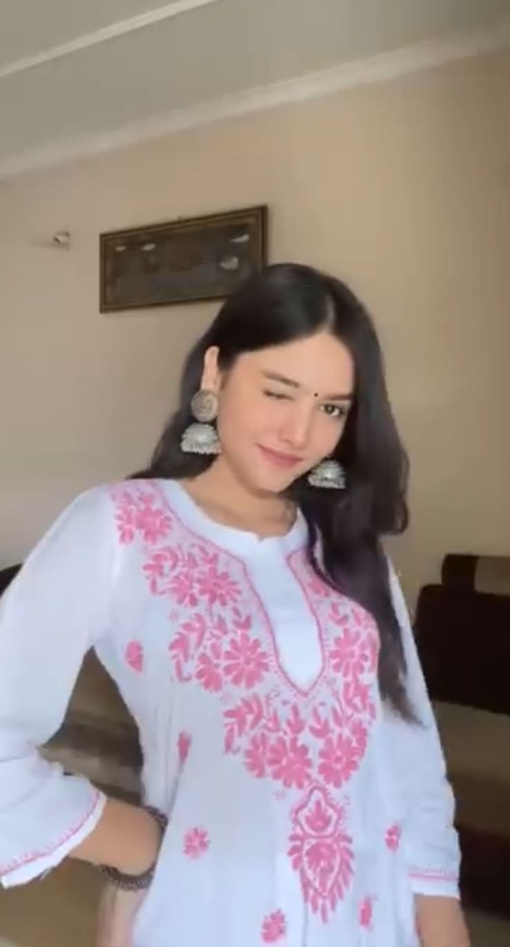 White cotton kurti with pink chikankari embroidery and silver jhumka earrings