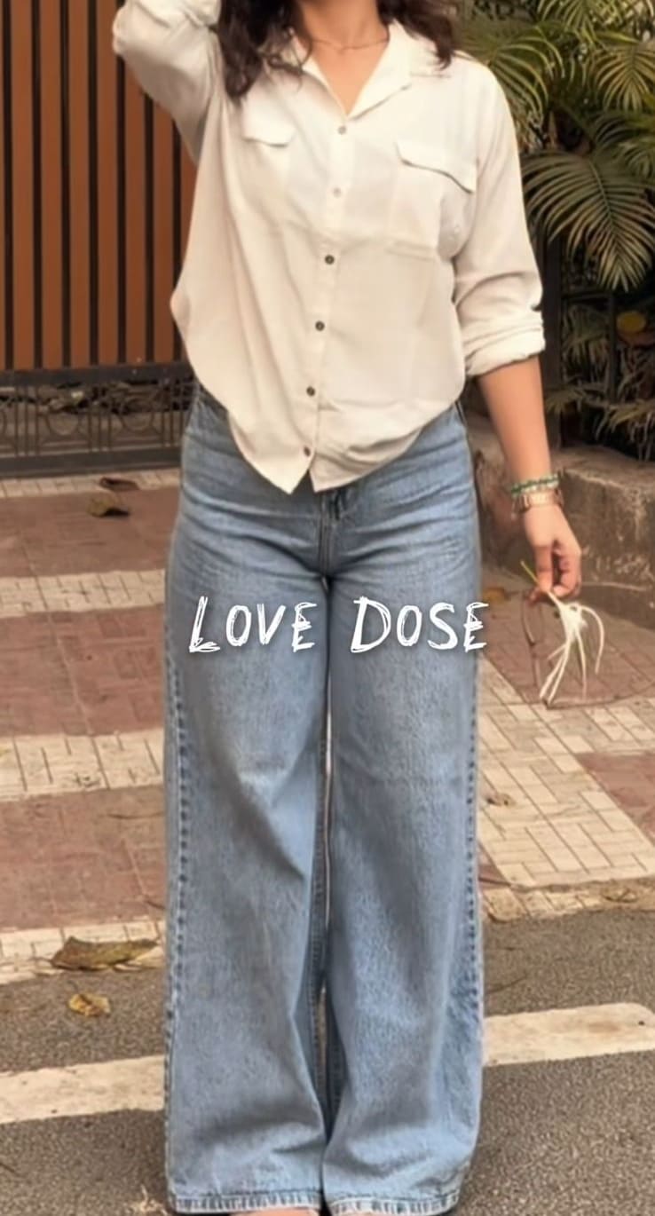 White utility shirt with double chest pockets and oversized wide-leg light jeans